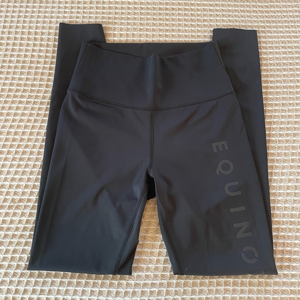 Black workout pants with Equinox written